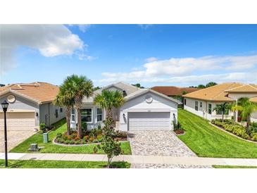 Single-Gathering home with a two-car garage and landscaped yard at 15503 Corona Del Mar Dr, Wimauma, FL 33598