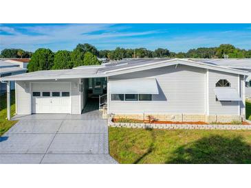 Single-wide manufactured home with attached garage at 34051 Brown Byu, Wesley Chapel, FL 33543