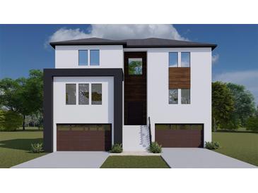 Modern two-story house with attached two-car garage, stairs and landscaping at 2221 S Occident St, Tampa, FL 33629
