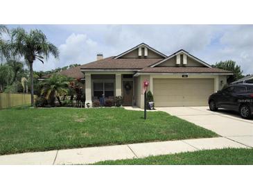 Single story home with attached garage and manicured lawn at 3464 Silverstone Ct, Plant City, FL 33566