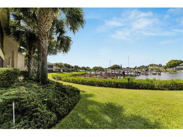 Landscaped backyard with a view of boats docked at a marina at 636 Yardarm Dr # 636, Apollo Beach, FL 33572
