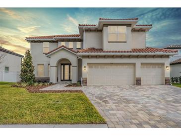 Beautiful two-story home with a three-car garage and a paved driveway at 7134 Heather Sound Loop, Wesley Chapel, FL 33545