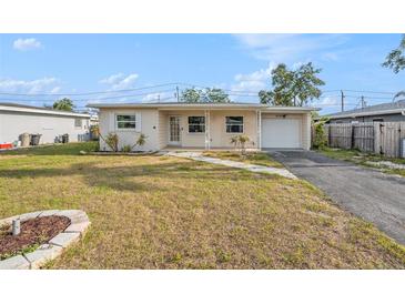 Charming single story home with a well-maintained front yard and a one car garage at 10735 64Th N Ave, Seminole, FL 33772
