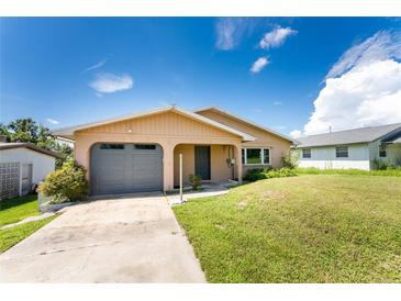 Single story home with grey garage door at 29171 Orva Dr, Punta Gorda, FL 33982
