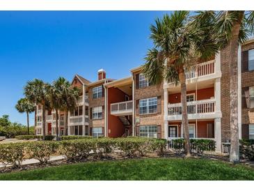 Brick apartment building with lush landscaping and palm trees at 10200 Gandy Blvd # 1116, St Petersburg, FL 33702