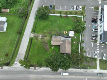 Aerial view of a house and lot situated near a road and other buildings at 11348 Pine St, Riverview, FL 33578