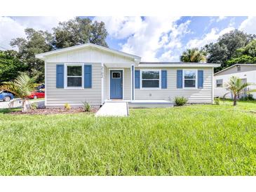 Newly built single-Gathering home with blue shutters and a green lawn at 2102 E Annie St, Tampa, FL 33612