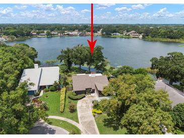 Stunning lakefront home with mature trees and a private setting at 8304 Palma Vista Ln, Tampa, FL 33614