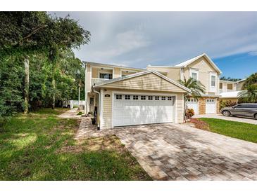 Two-story home with a two-car garage and landscaped yard at 903 Woodbridge Ct, Safety Harbor, FL 34695