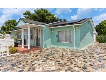 Charming light teal home with a stone driveway at 8816 Ascot Ct, Tampa, FL 33634