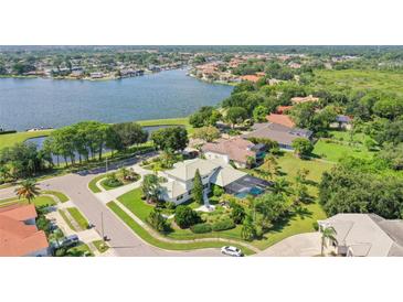 Two-story house with a green roof and a pool, located in a waterfront community at 5709 E Longboat Blvd, Tampa, FL 33615