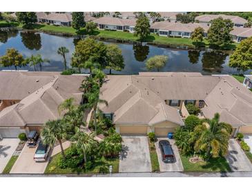 Community view showcasing homes near a lake at 630 Tremont Greens Ln # 95, Sun City Center, FL 33573