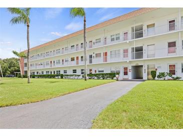 Two-story building with balconies and a well-maintained lawn at 5728 14Th N Ave # 104B, St Petersburg, FL 33710