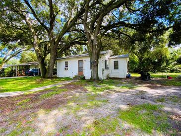 Quaint cottage-style home nestled under large shade trees at 5907 8Th S Ave, Tampa, FL 33619