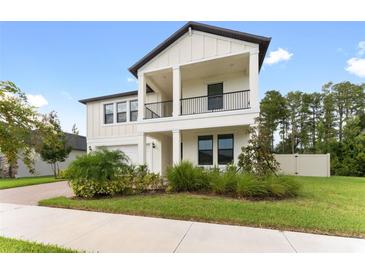 Two story house with balcony and landscaping at 9848 Wild Begonia Loop, Land O Lakes, FL 34637