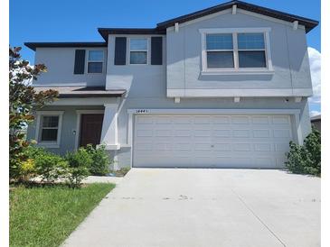 Two-story house with gray siding, dark brown accents, and a two car garage at 14443 Touch Gold Ln, Sun City Center, FL 33573