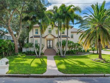 Two-story home with palm trees, brick walkway, and double front doors at 2501 N Dundee St, Tampa, FL 33629