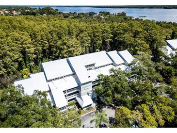 Aerial view of waterfront community building with lake access at 2511 Dolly Bay Dr # 301, Palm Harbor, FL 34684