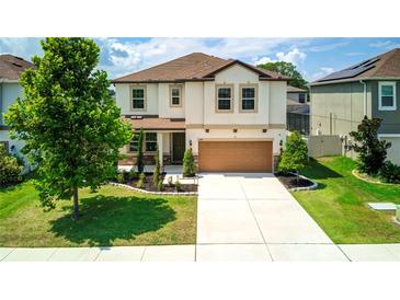 Two-story house with a brown garage door and stone accents at 1181 Montgomery Bell Rd, Wesley Chapel, FL 33543