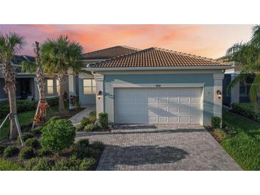 Stunning curb appeal with a two-car garage and landscaped yard at 4838 Sevilla Shores Dr, Wimauma, FL 33598