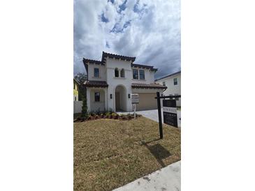 Stunning two-story home with a tile roof, manicured landscaping, and a welcoming front entrance at 320 W Park Ave, Tampa, FL 33602