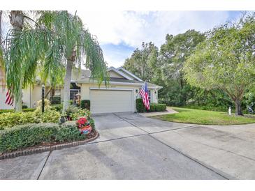 Single-story home with attached garage and landscaped yard at 2447 Nantucket Harbor Loop # 112, Sun City Center, FL 33573