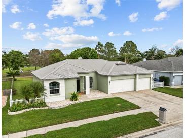 Charming single-story home features a well-manicured lawn and a three-car garage at 13102 Prestwick Dr, Riverview, FL 33579