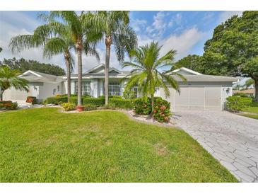 Single-story home with a landscaped yard, driveway, and attached garage at 902 Mcdaniel St # 1, Sun City Center, FL 33573