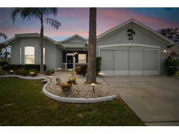 Well-maintained house with a two-car garage and landscaping at 1119 Villeroy Dr, Sun City Center, FL 33573