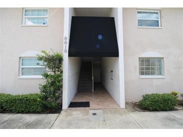 Building exterior showing entrance with stairs and awning at 8818 Bay Pointe Dr # 108, Tampa, FL 33615