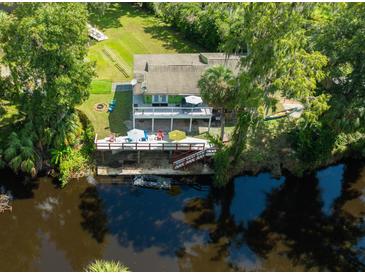 Stunning waterfront home with a spacious deck and lush landscaping at 4617 John Moore Rd, Brandon, FL 33511