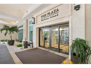 The Plaza Harbour Island building entrance with automatic doors and landscaping at 450 Knights Run Ave # 411, Tampa, FL 33602