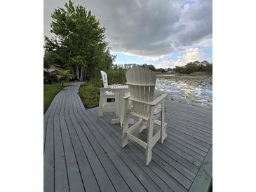 Relaxing waterfront dock with seating, offering peaceful lake views at 6404 Land O Lakes Blvd., Land O Lakes, FL 34638