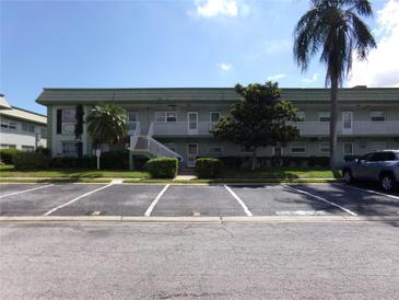 Front view of a light green building with parking in front at 1433 S Belcher Rd # A8, Clearwater, FL 33764