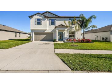 Two-story home with attached garage and landscaping at 3172 Lytton Hall Dr, Zephyrhills, FL 33540