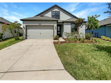 One story home with gray siding and two car garage at 13292 Sea Bridge Dr, Hudson, FL 34669