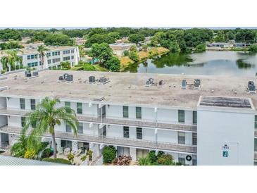 Exterior view of a condo building overlooking a lake at 1655 S Highland Ave # J390, Clearwater, FL 33756