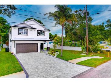 Two-story home with modern design and paver driveway at 1105 Conant Ave, Safety Harbor, FL 34695