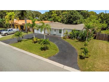Charming single story home with a circular driveway and lush landscaping at 6685 17Th N St, St Petersburg, FL 33702