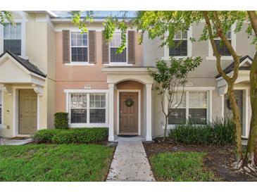 Two story townhome with a brown door and neutral colors at 4538 Kennewick Pl, Riverview, FL 33578