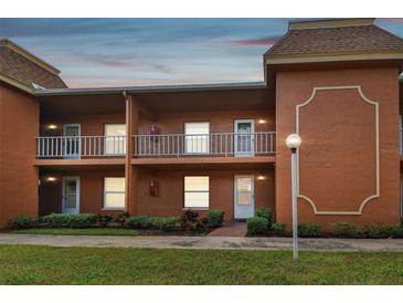 Two-story building, featuring multiple units with balconies and well-maintained landscaping at 12760 Indian Rocks Rd # 910, Largo, FL 33774