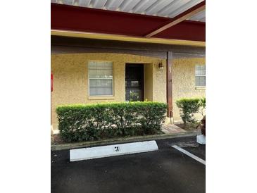 Condo building exterior with covered parking at 601 N Hercules Ave # 103, Clearwater, FL 33765