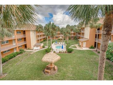 Community courtyard featuring a pool and picnic area at 12760 Indian Rocks Rd # 510, Largo, FL 33774