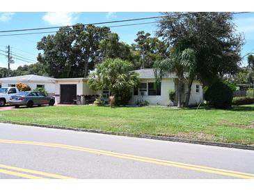 Single-story home with a green lawn and driveway at 2109 58Th S St, Gulfport, FL 33707