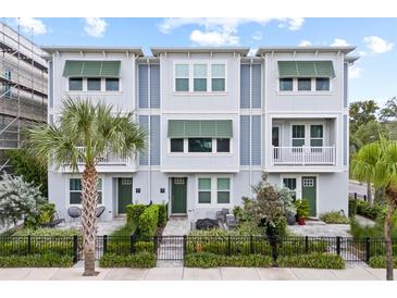 Charming townhome featuring a modern facade, lush landscaping, and inviting outdoor spaces at 2510 W Cleveland St # 2, Tampa, FL 33609