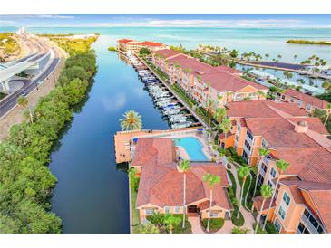 Stunning aerial view showcasing the waterfront condos, boat docks, and beautiful community pool at 5000 Culbreath Key Way # 4-306, Tampa, FL 33611