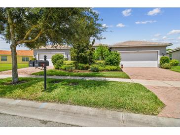 Two-car garage home with nicely landscaped yard at 15626 Aurora Lake Cir, Wimauma, FL 33598