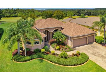 Attractive one-story home with landscaped yard and three-car garage, situated on a golf course at 13217 Thoroughbred Dr, Dade City, FL 33525