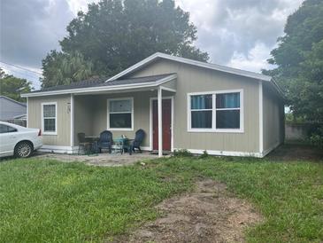 House exterior featuring a neutral color palette and front yard at 9463 Arbol Ct, Largo, FL 33773