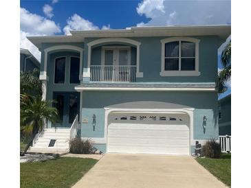 Two-story home with a light blue exterior and a two-car garage at 6140 Seaside Dr, New Port Richey, FL 34652